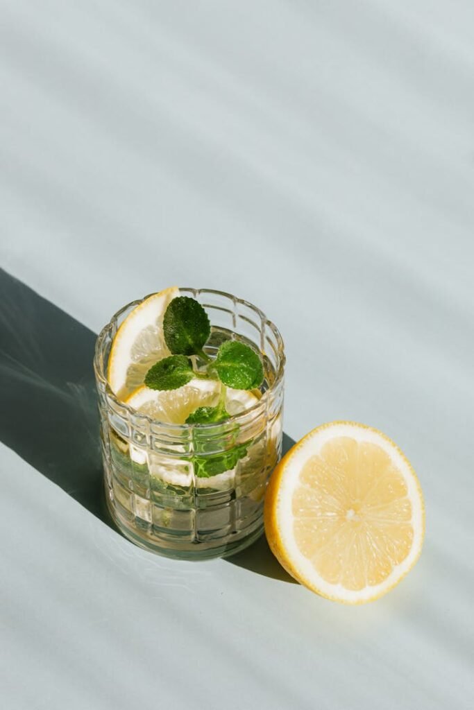 Glass of refreshing drink on table